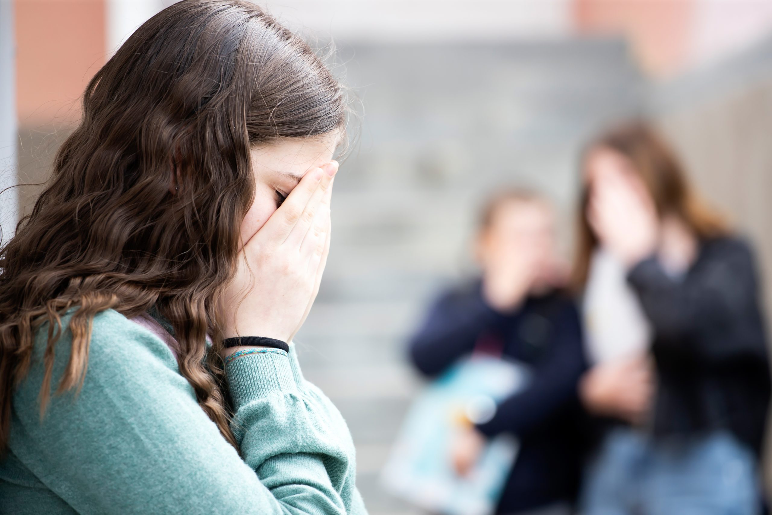 Girl being bullied at the school. Educational school isolation and bullying concept.