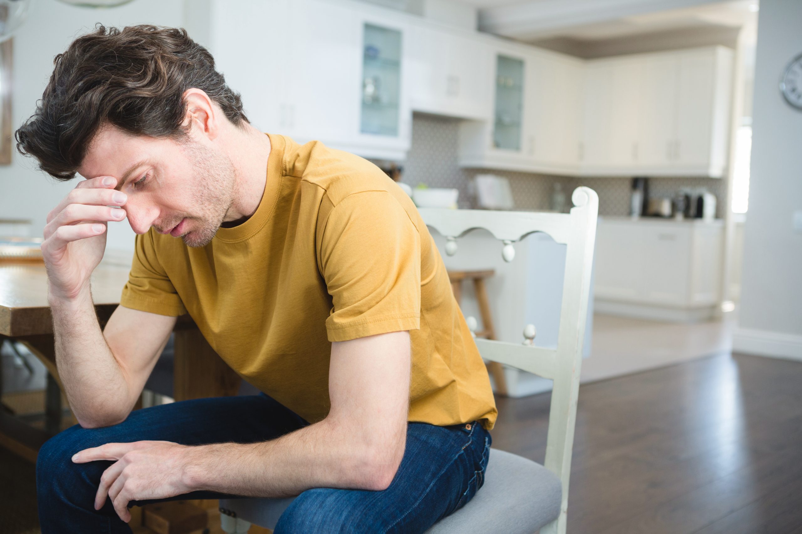 Worried young man sitting at home