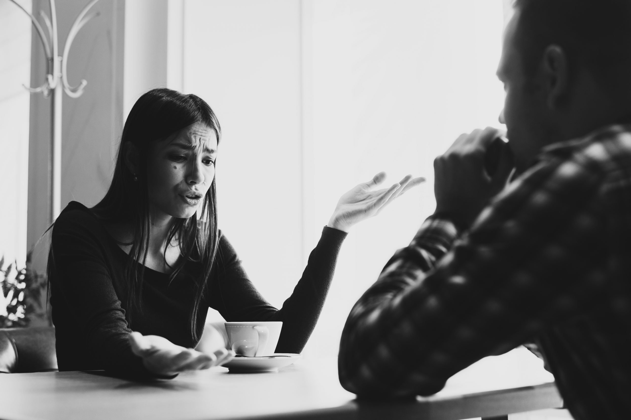 Young couple arguing in a cafe. Relationship problems