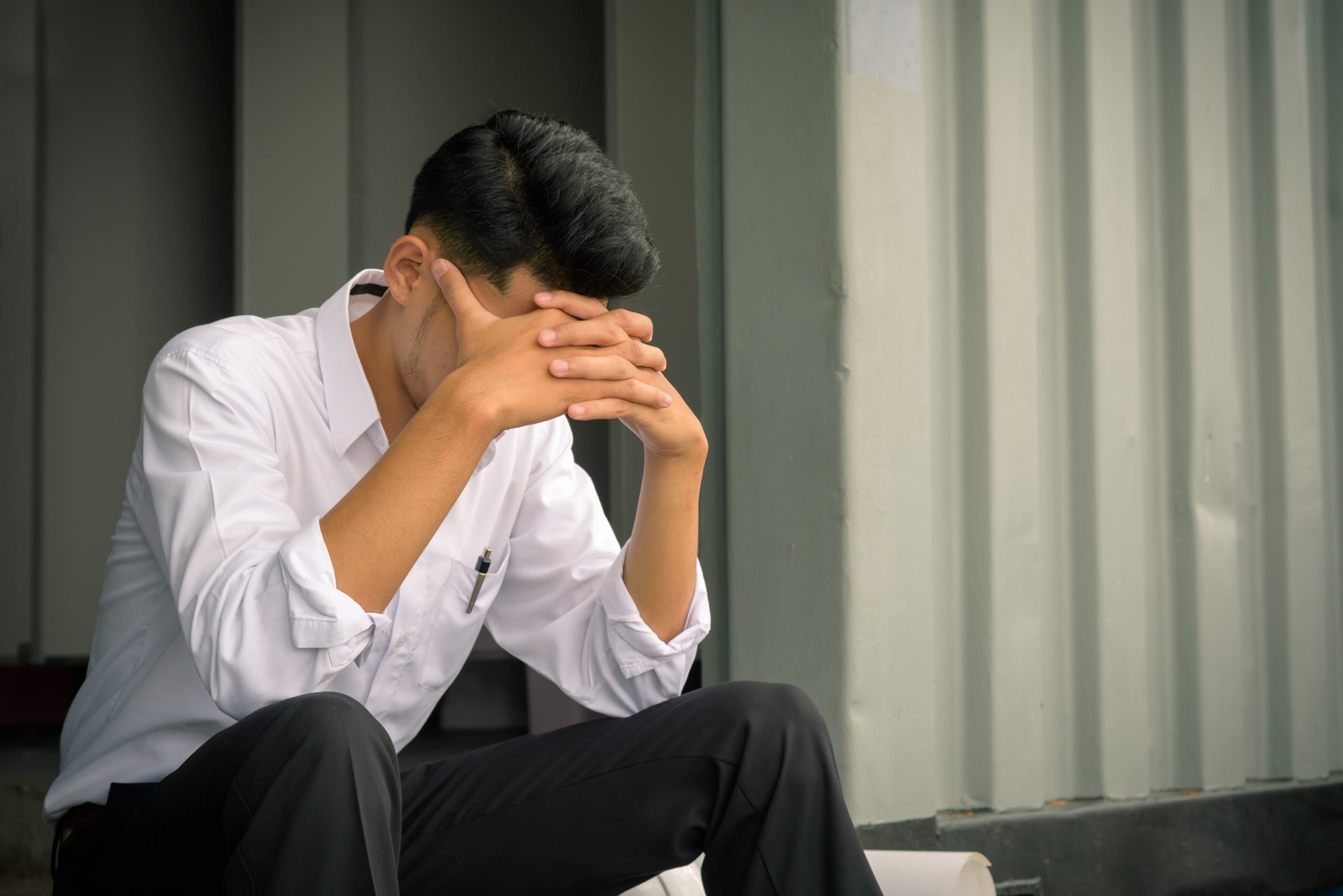 Portrait of worried businessman sitting after losing job, stressed concept