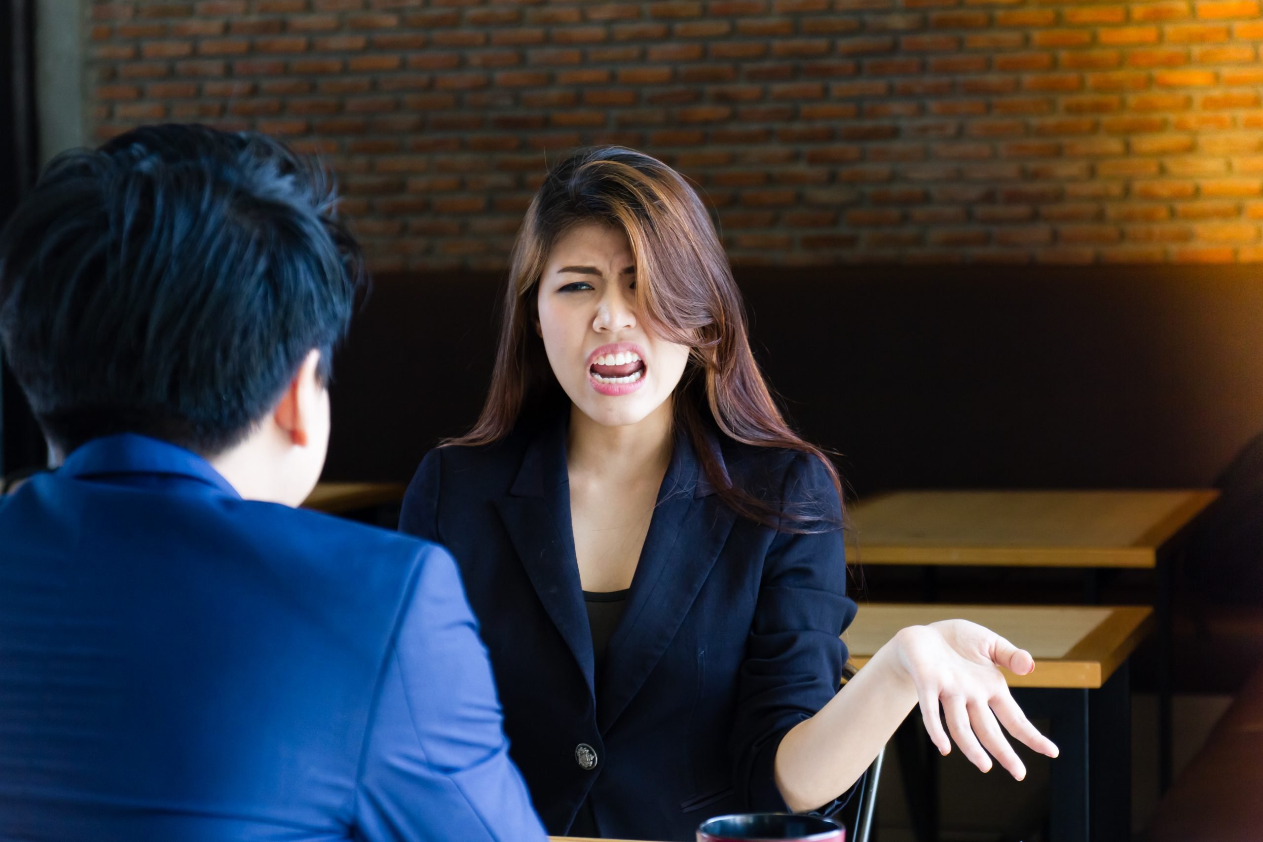 Young business people arguing about mistaken work.