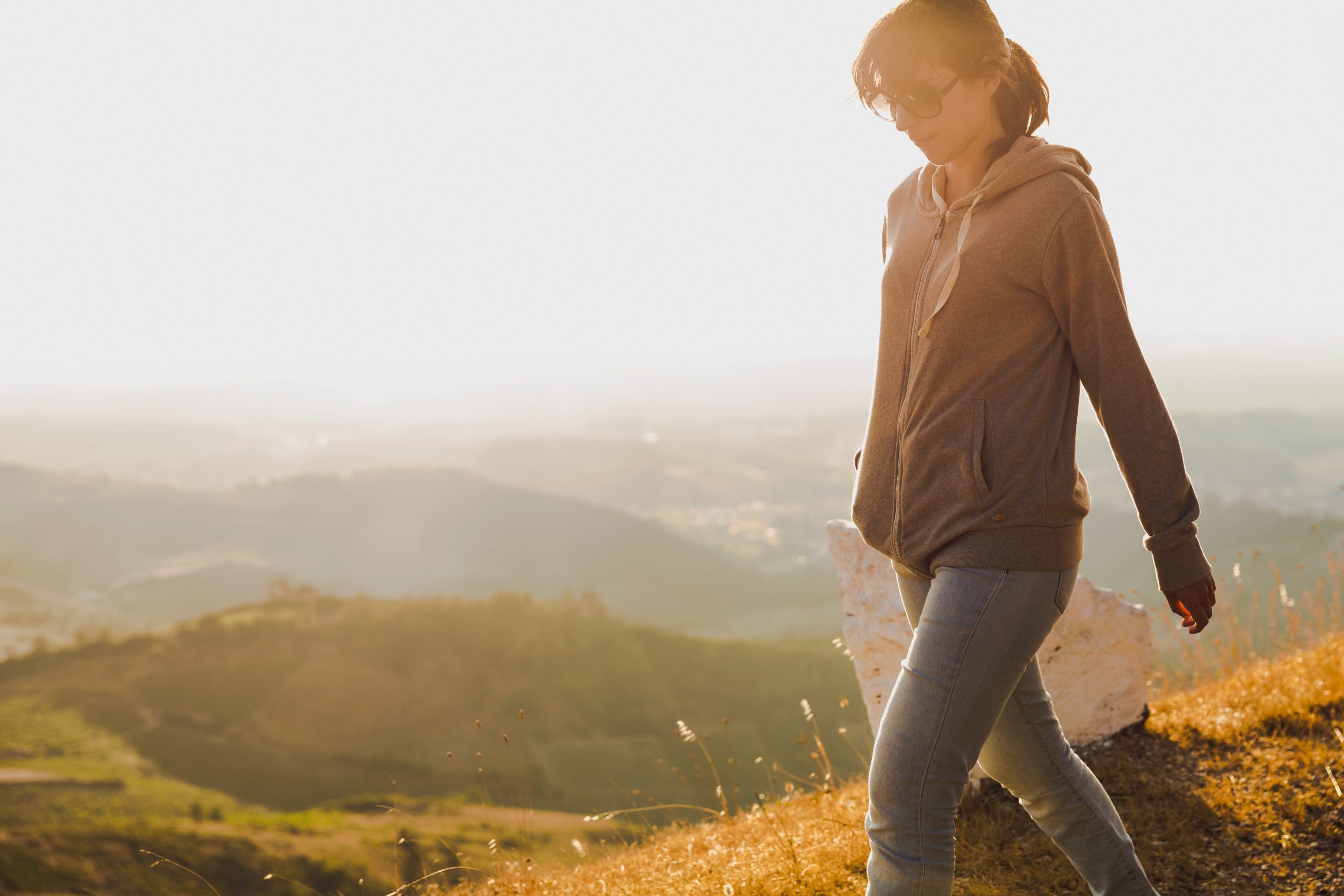 Woman walking alone on a sunny aftternoon