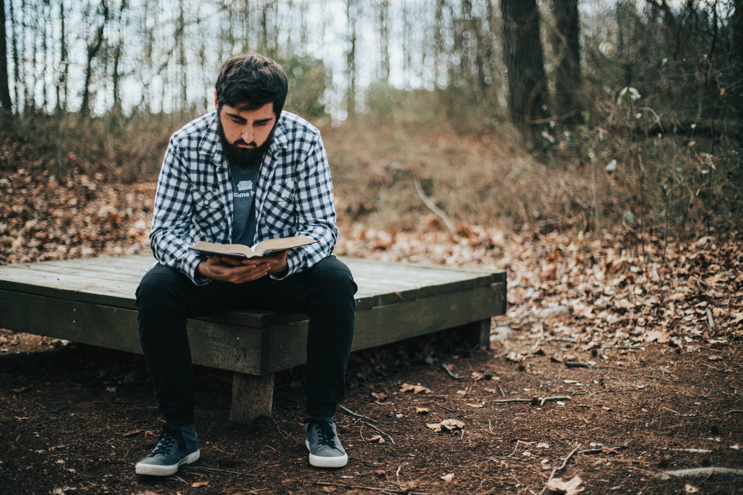 man-reading-his-bible-in-the-woods-2022-03-06-04-19-35-utc