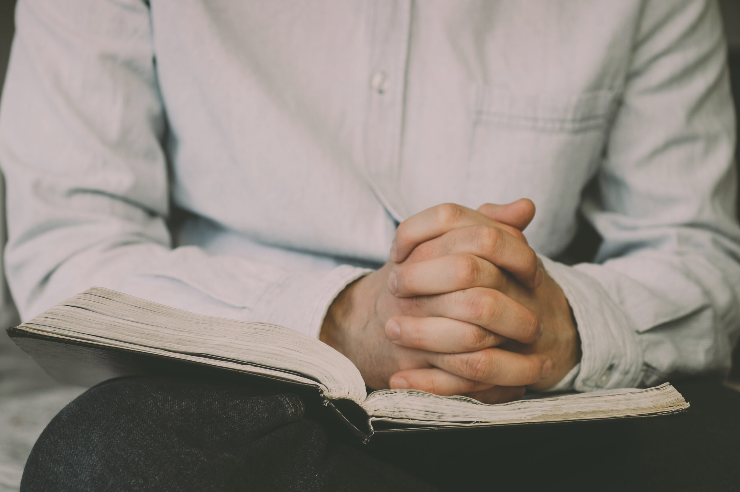 The Christian holds the Bible in his hands. Reading the bible. The concept of faith, spirituality and religion.