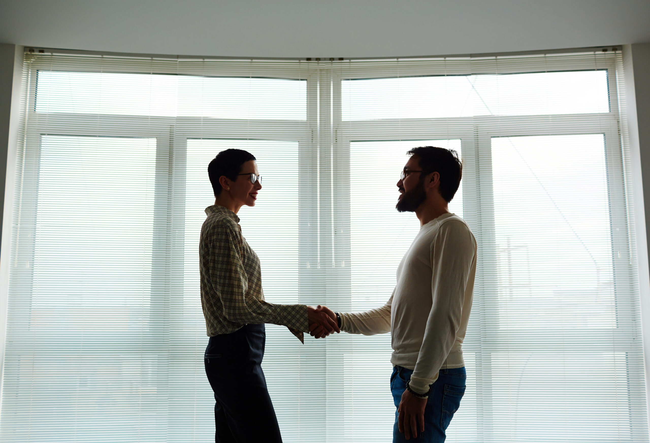 Successful leaders greeting one another after striking business deal