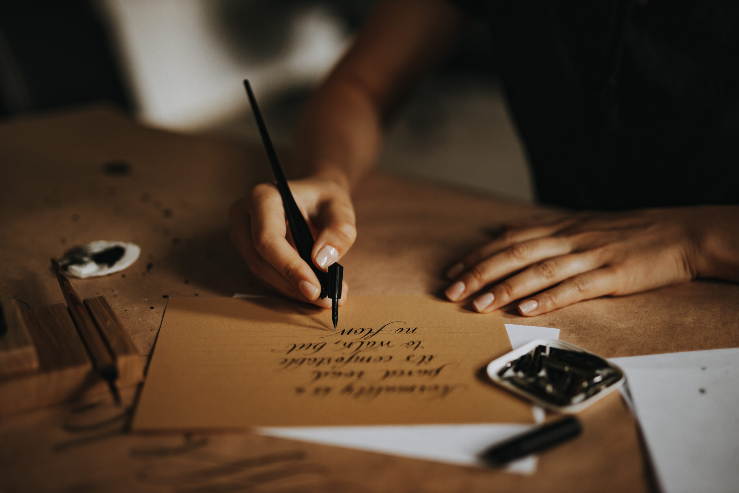 Writing a letter with old fashioned fountain pen. Lettering and calligraphy.