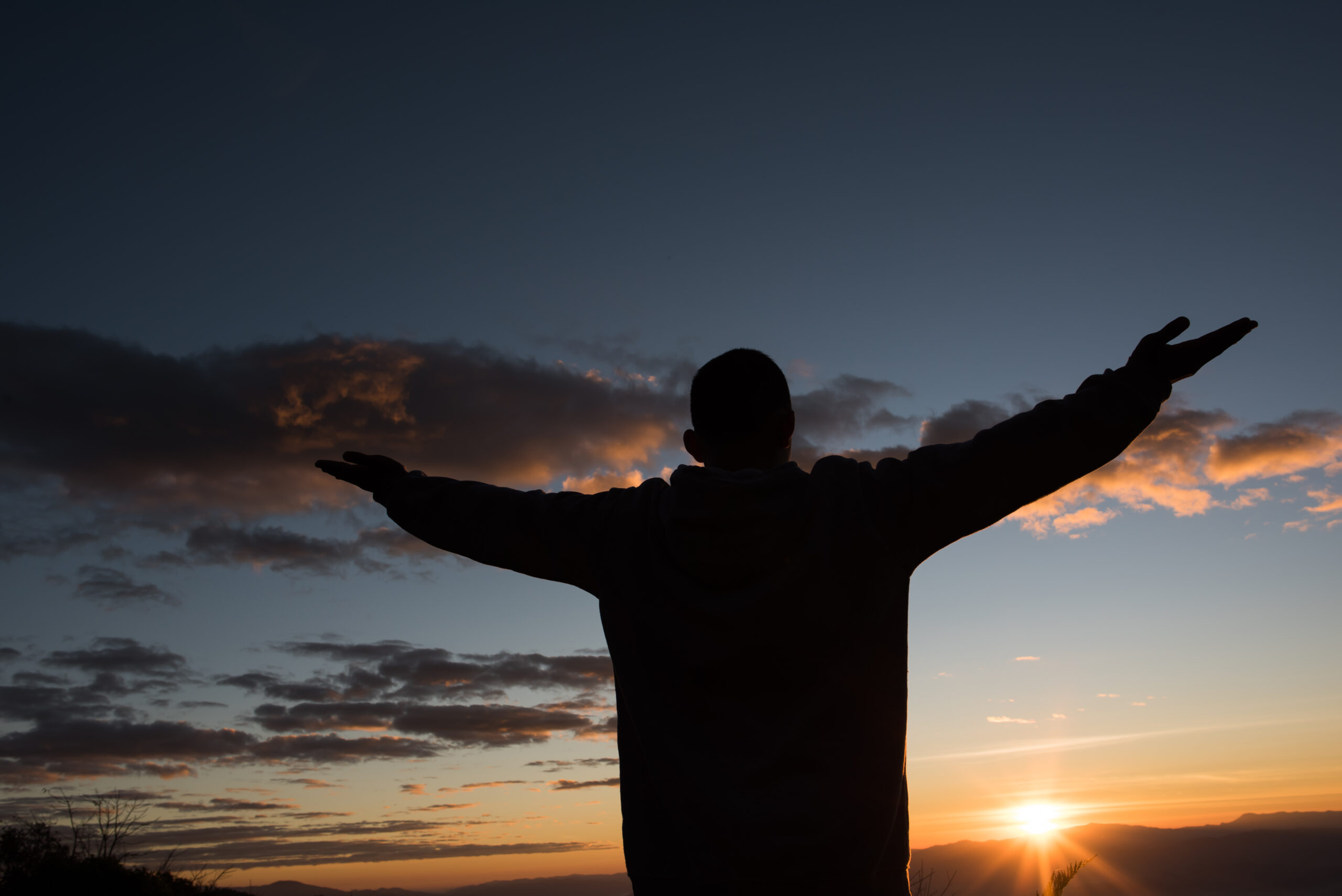 Silhouette of People raising Hand of God