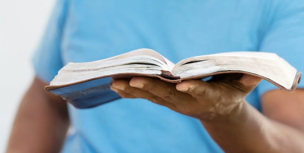 36897-manholdingBible-thinkstock.1200w.tn