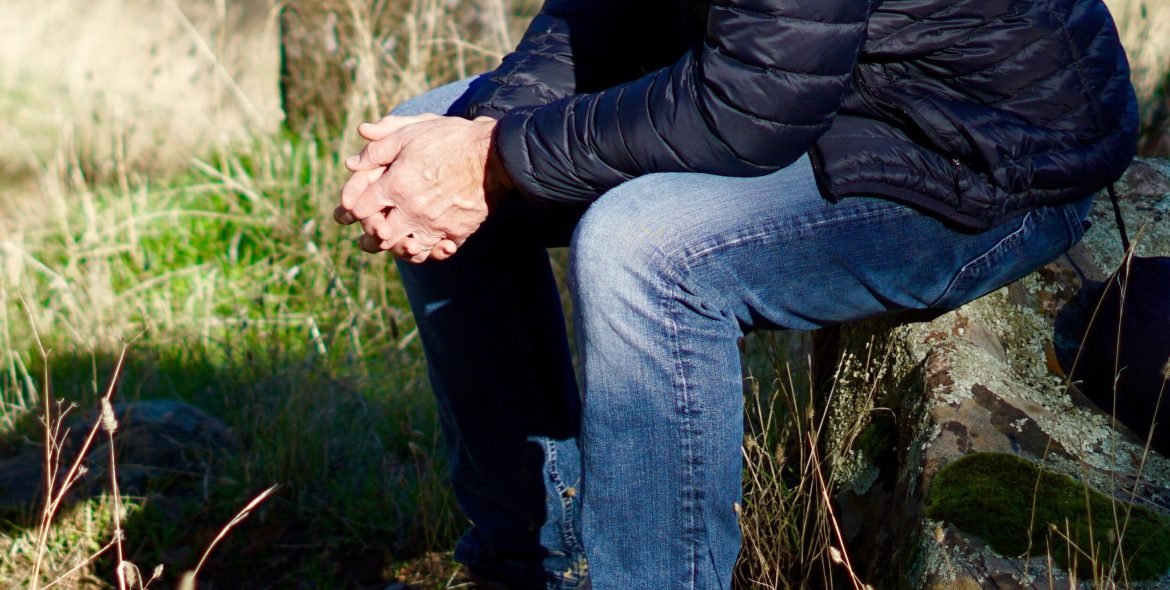 a-man-sitting-with-hands-together-nominated-M86QHDM