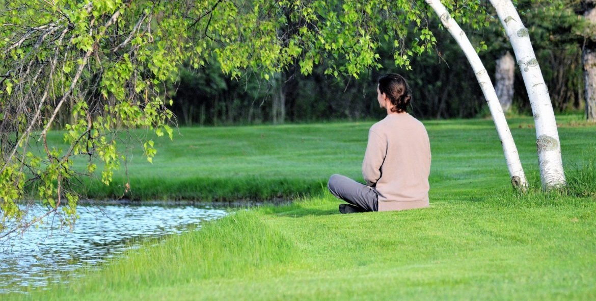 a-person-sitting-near-a-pond-under-a-birch-tree-enjoying-yoga-meditation-yoga-meditation-outdoors_t20_a7poQQ 2