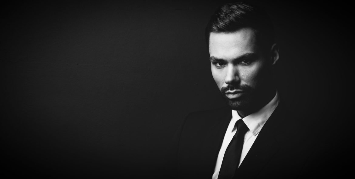 Black and white portrait of young businessman in a suit. Stylish person.