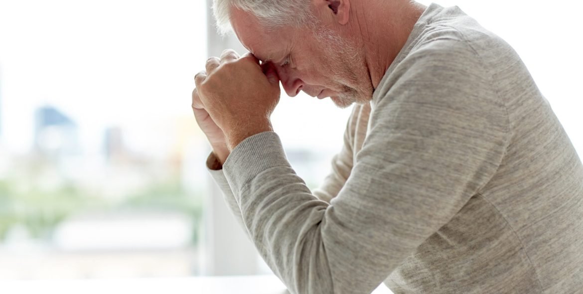old age, problem and people concept - close up of senior man thinking