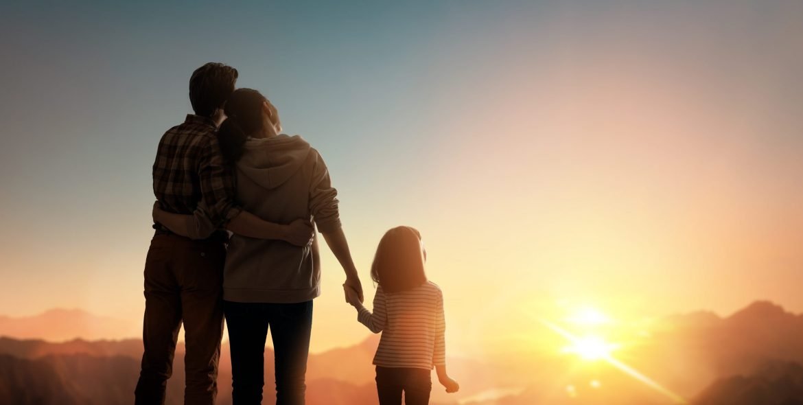 Happy family at sunset. Father, mother and child are having fun and enjoying journey.
