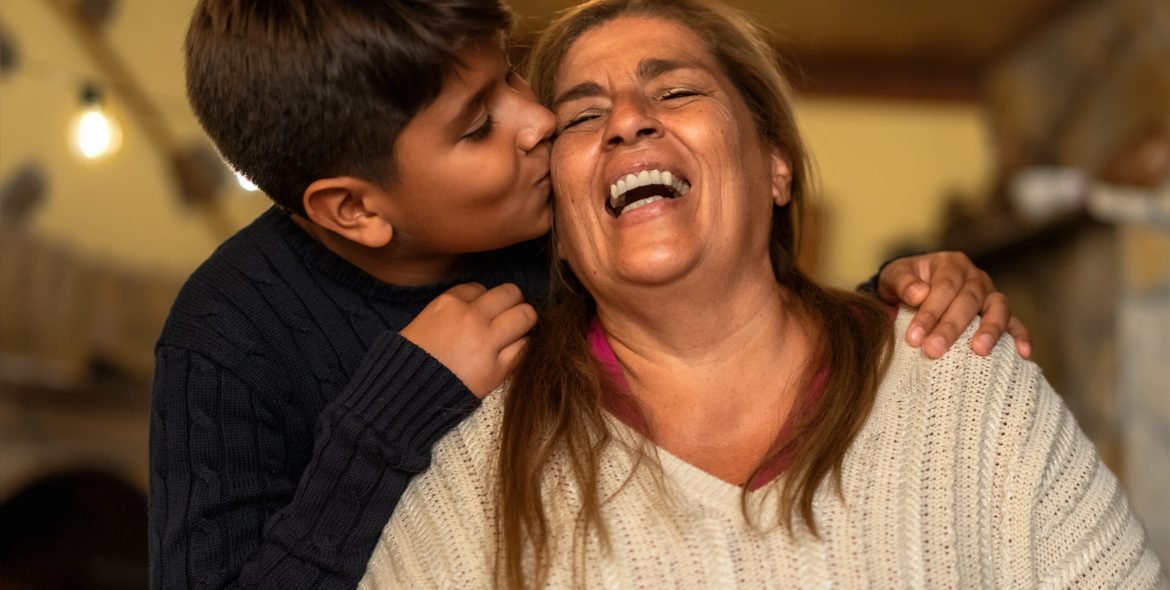 Happy smiling Hispanic grandmother and his grandchild having tender moment together - Family love and unity concept