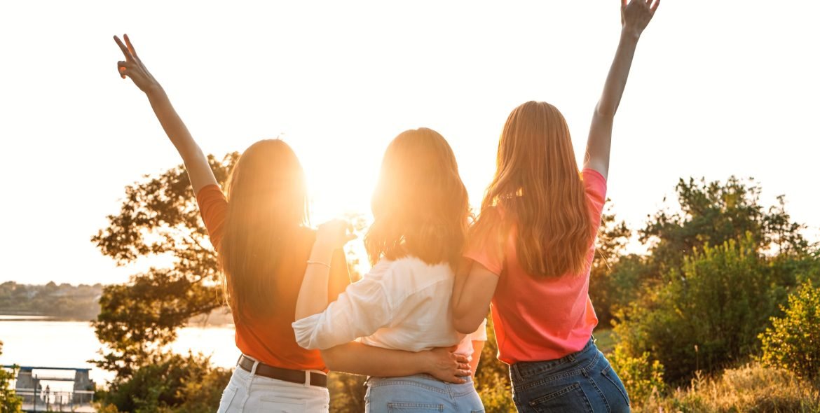International Womens Day. Women, Female, Feminism, Friends, Girl power, diversity, femininity Concept. Group of three happy young women having fun outdoor.