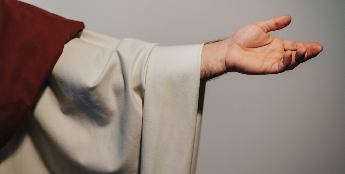 Close up of hand of Jesus Christ who is blessing the people