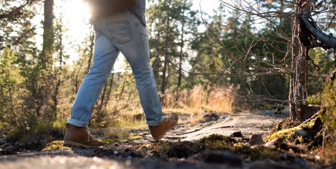 Man walking on a path through the forest. Rear. view