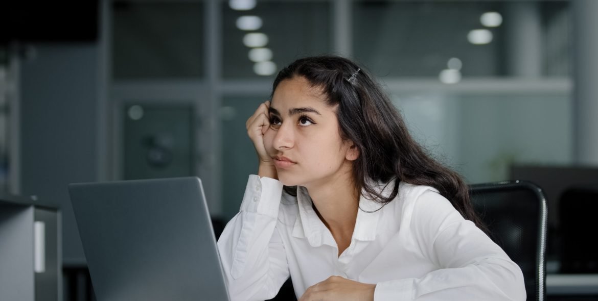 Sad bored lazy young woman typing on laptop tired unmotivated businesswoman office worker feels fatigue from working at computer suffers from overwork distracted from boring dull job feeling exhausted. High quality 4k footage