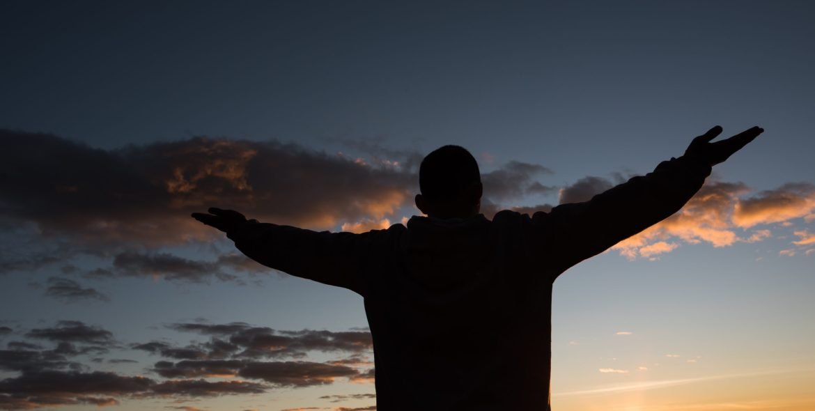 Silhouette of People raising Hand of God
