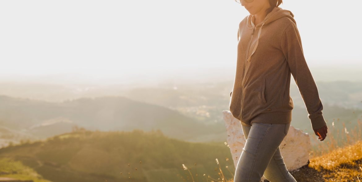 Woman walking alone on a sunny aftternoon
