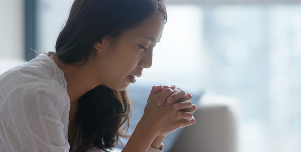 Woman pray to god at home