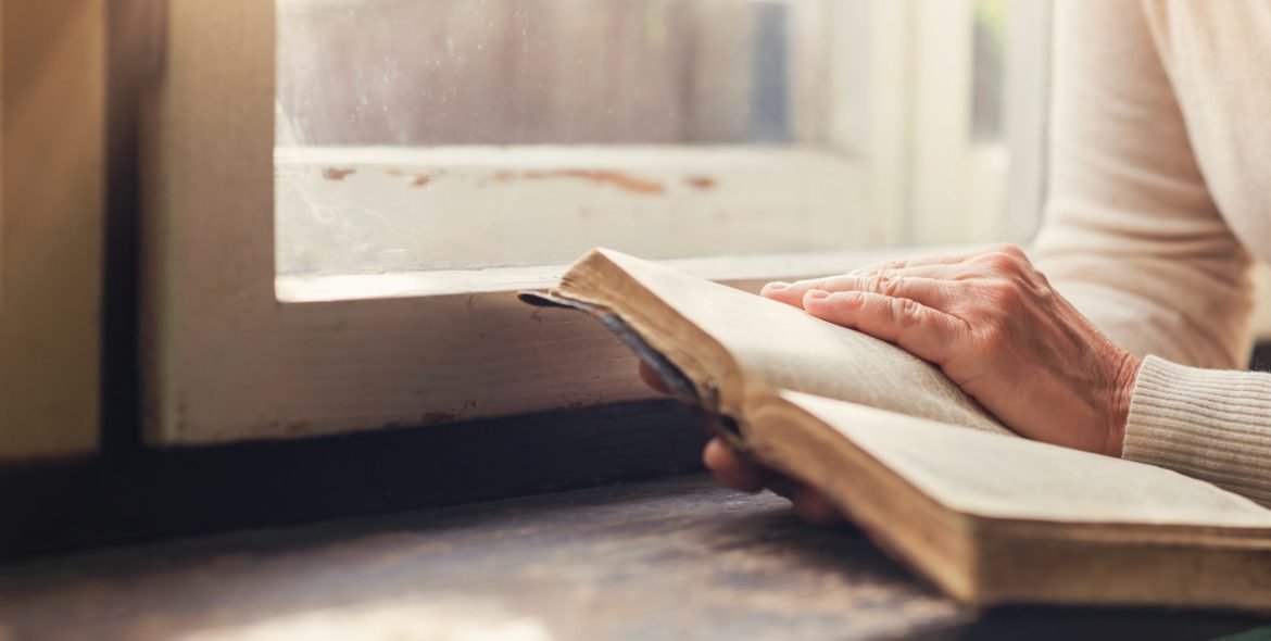 Unrecognizable woman holding a bible in her hands