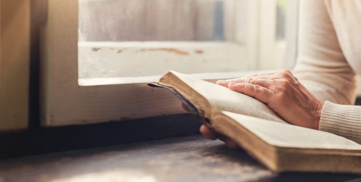 Unrecognizable woman holding a bible in her hands