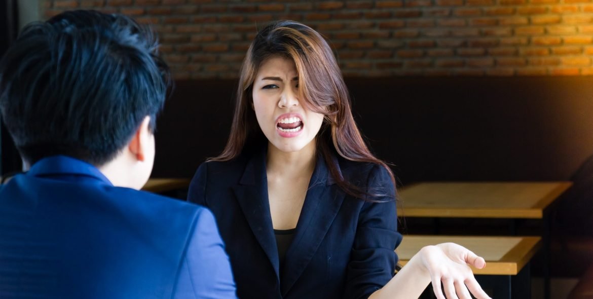 Young business people arguing about mistaken work.
