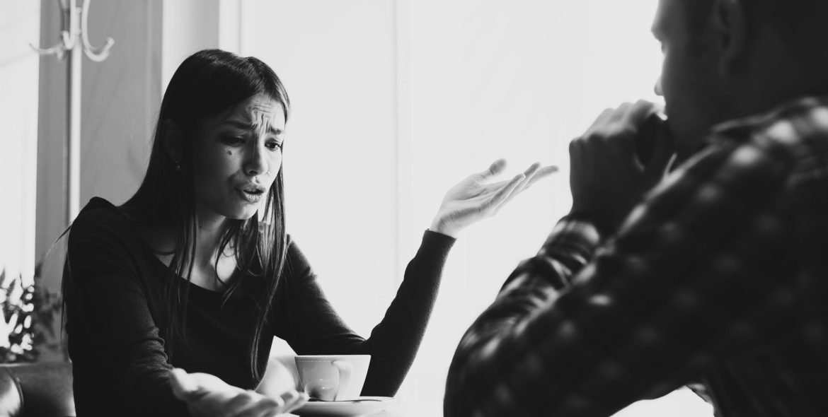 Young couple arguing in a cafe. Relationship problems