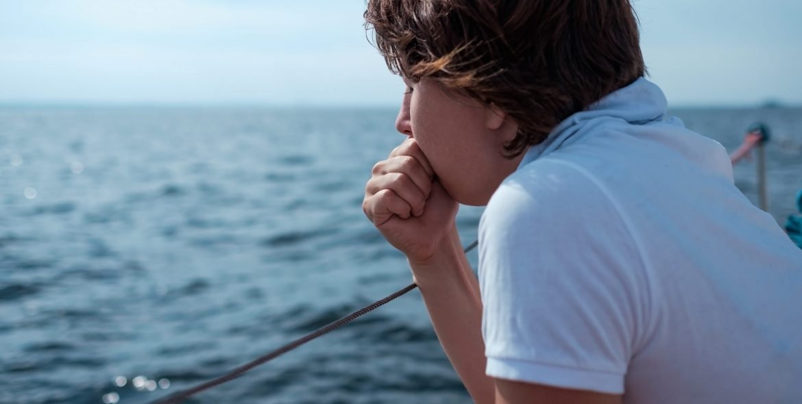 Young woman suffer from seasickness during vacation on boat or yacht